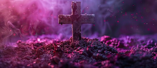 A cross made of ashes is displayed on a deep purple backdrop providing room for a copy space image