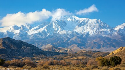 Fototapeta premium Snowy peaks of the Sierra Nevada mountains with a bright sky, leaving space for text