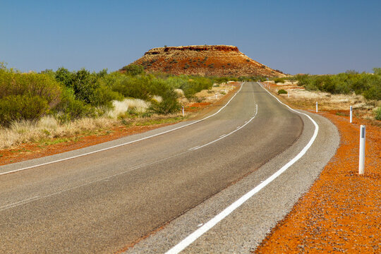 A highway view of a tabletop hill in the Pilbara
