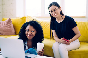 Diverse teenagers smiling during studies at home