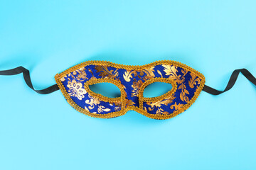 One beautiful carnival mask on light blue background, top view