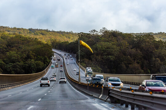 wind sock above highway road bridge crossing river in national park