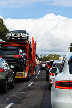 Truck transporting cars and traffic stopped on highway headed into Sydney