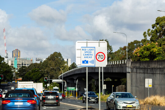 Red light speed camera ahead sign at intersection in Sydney