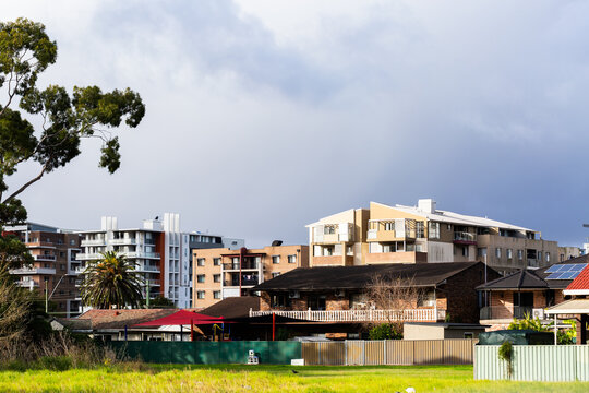 City building sin Sydney suburb with dramatic sky above