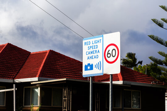 red light speed camera ahead sign in 60 speed zone in city