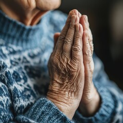 Fototapeta premium A close-up of an elderly person with hands clasped in prayer, participating in a mindfulness session