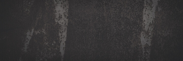 Old rusted metal texture. Rusty iron wall. Rough faded metal surface with spots, noise and grain. Dark wide panoramic background for grunge design. Shaded vintage texture with vignette.