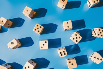 A vibrant display of wooden dice rolling and scattering across a bright blue background, capturing the essence of playful chaos and randomness