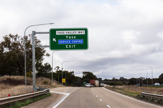 Highway with directions on sign to Yass Valley Way service centre exit