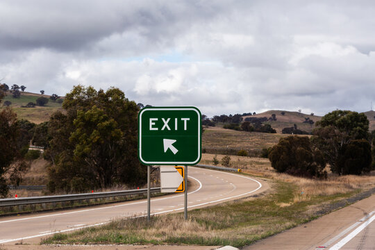 Naklejki Exit sign beside rural country highway in Australia on dreary overcast day