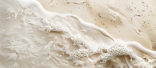 Obraz premium Beach themed wallpaper with a sandy texture and beige color perfect as a copy space image of a wet sand beach