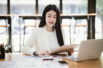 Asian businesswoman working with laptop in office