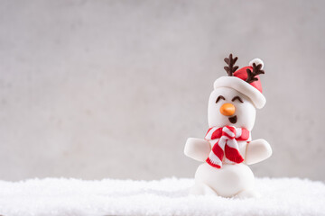 Happy funny marshmallow snowmans on snow