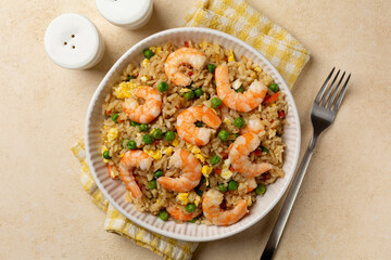 Top view of Homemade prawns or shrimp fried rice with fried eggs, vegetables, onion, green pea, carrot.