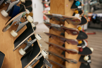 Professional skateboards new collection on rack at sports shop © Nomad_Soul