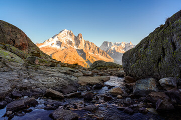 French alps mountain with stream flowing in rocky valley at Lac Blanc, France
