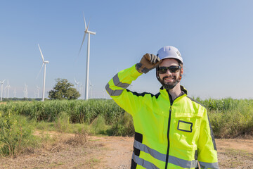 Portrait of engineer pose at wind turbines field