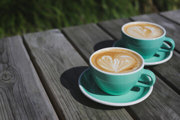 Two beautiful cups with delicious double cappuccino. Beautiful latte art.