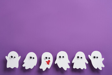 Cute ghosts with eyes on purple background, one ghost holding a red heart, Halloween horizontal banner, space for your text