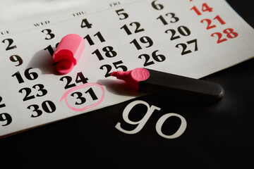 A calendar with the date 31 circled in pink marker and the word 