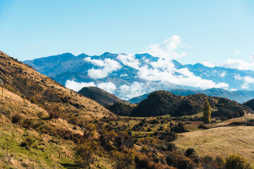 Scenic view of mountain with foggy over autumn hill from summit of Roys Peak in the morning
