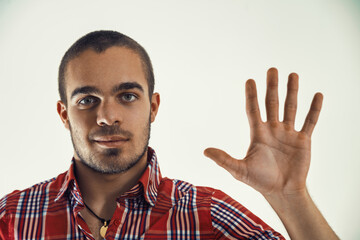 Naklejka premium Young man pointing to numbers and figures on a virtual screen