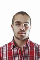 Young man with short hair and red shirt posing on white backgrou