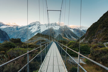 Obraz premium View of suspension bridge with mountain range on Hooker Valley Track in national park at New Zealand
