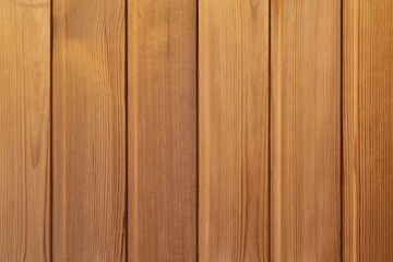 Wooden background, beautiful clean even wood structure. Texture of wooden planks with vertical stripes, waves, age rings