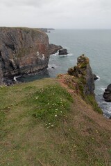 View of rugged cliffs and sea on a cloudy day. Pembrokeshire Coast National Park, Wales