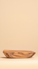 Fototapeta premium Wooden serving platter on beige background, perfect for displaying snacks or as a decorative kitchen element.