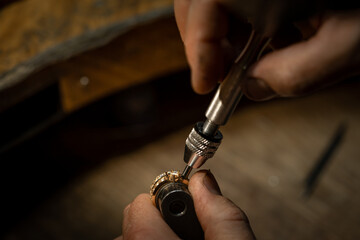 The work of jewelers. Trial jewelry of semiprecious metals. Ring. Selective focus. Macro photo.