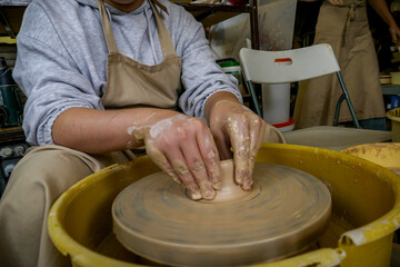 hands on a potter's wheel in clay making a ceramic product, workshop, entertainment, potter, learning, tour, entertainment