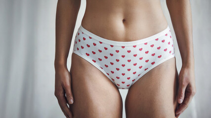Obraz premium young woman wearing white cotton panties underwear with red love hearts