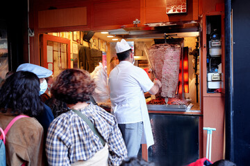 Turkish Kebab donner meat cooking on large skewers in a take away sandwich shop