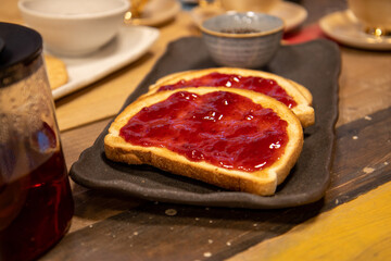 A plate of delicious jam on toast at breakfast time in a kitchen