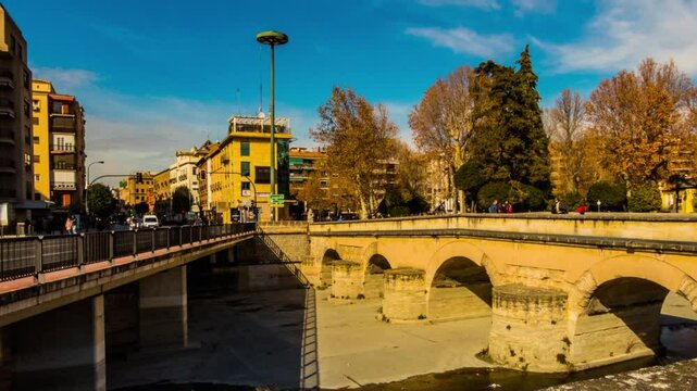 GRANADA, SPAIN - JANUARY 29 2017: Roman Bridge over Genil River. This bridge is located within urban area of Spanish city of Granada, Andalusia, on Genil River, just at its confluence with Darro River