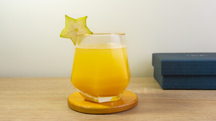 A glass of fresh star fruit juice on table