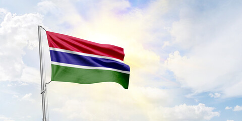 Gambia flag waving on sky background. 3D Rendering
