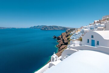 Obraz premium Cerulean-tiled rooftop in Santorini, with whitewashed buildings and the deep blue Aegean Sea in the background