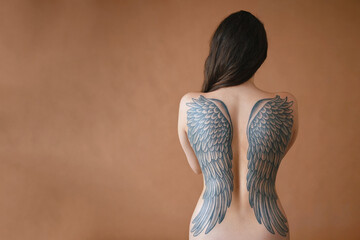 Woman with angel wings tattoo on her back