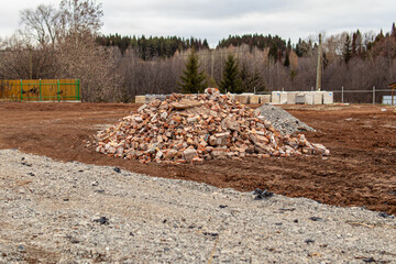 Pile of old broken bricks at construction site. Construction debris
