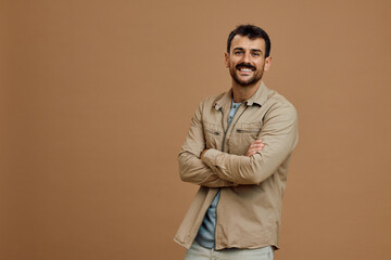 Portrait of happy man with arms crossed looking at camera.