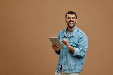 Studio shot of happy man using digital tablet and looking at camera. © Drazen