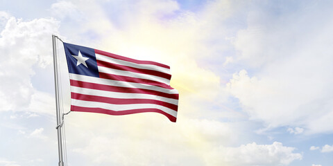 Liberia flag waving on sky background. 3D Rendering
