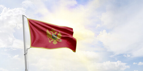 Montenegro flag waving on sky background. 3D Rendering