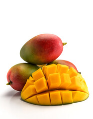 mangoes whole and sliced scattered around background concept isolated white