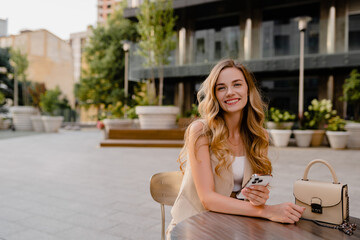 Fototapeta premium woman sitting in cafe with phone