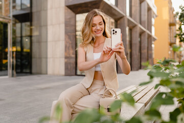 woman sitting in city street with phone